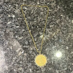 2" Gold angel medallion outlined in rhinestones clasp attached to gold 18" chain